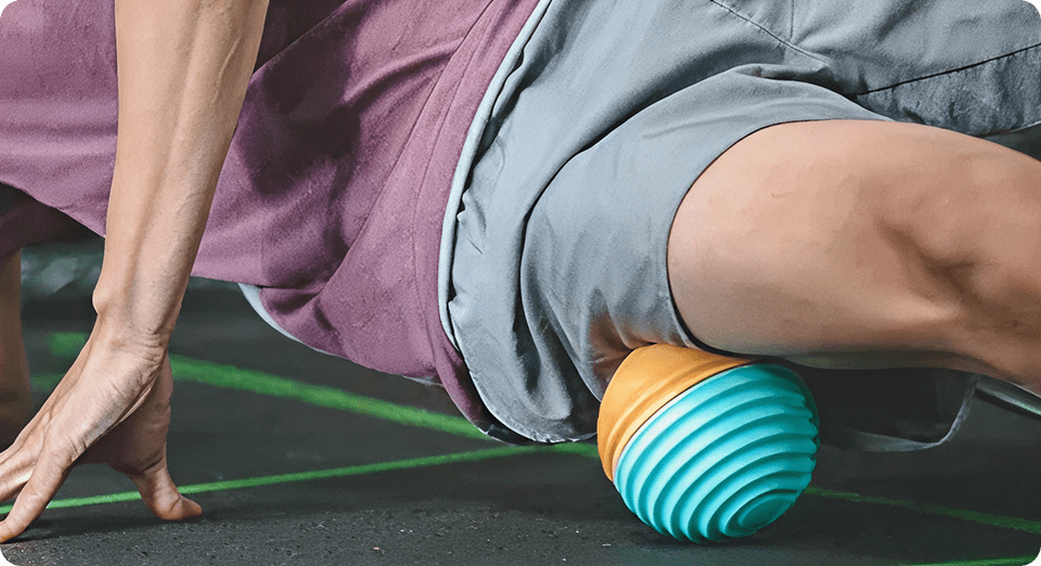 Person using massage ball for leg therapy